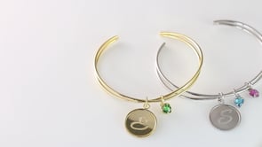 Infinity Bracelet with initial letter and birthstone charms, a perfect representation of the treasured relationships in your life.